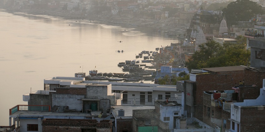 An evening skyline of Varanasi, India, featuring ancient temples and buildings.