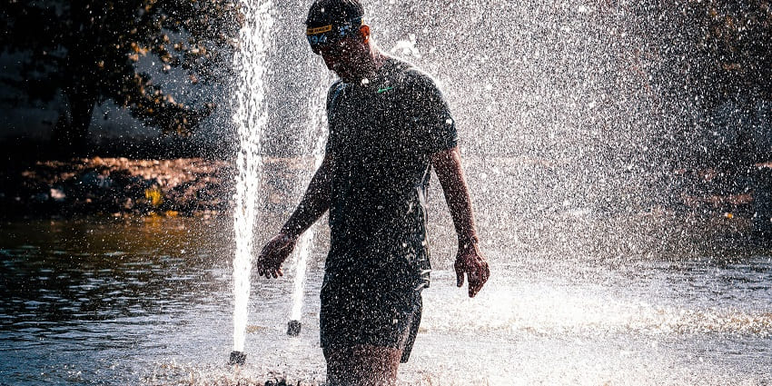 A view of a man enjoying a water fountain at a famous waterpark in Varanasi.