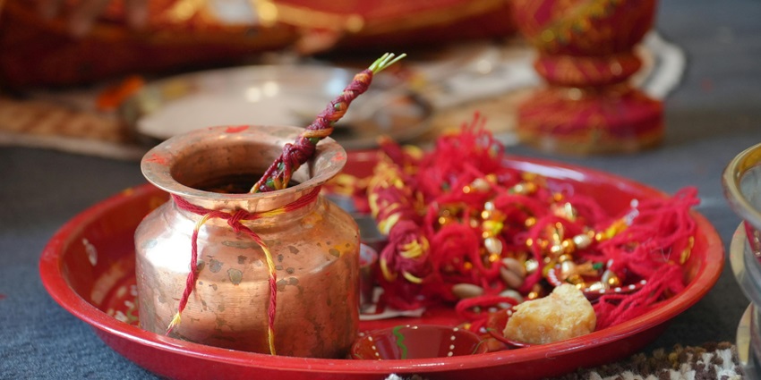 Pooja thali with traditional articles like diya, flowers, and incense sticks used in Hindu rituals