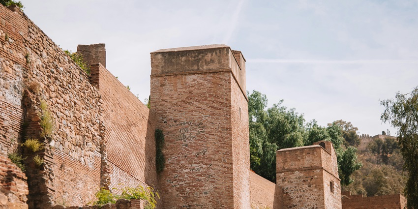 Majestic fortification walls and towers, a historic tourist attraction nearby