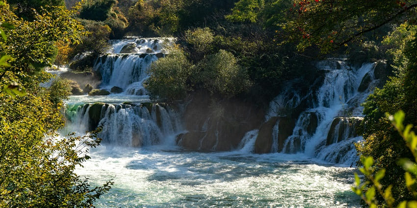 A picture of heavy water flow at Bhalu Gaad Waterfalls, causing splashes all around