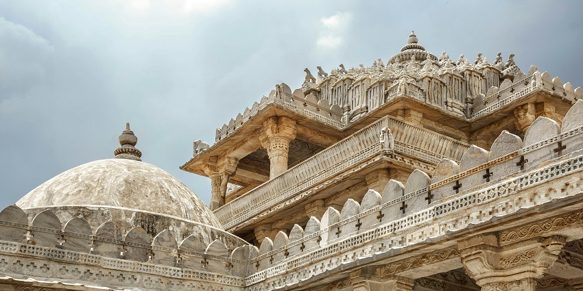Ancient temple ruins with stone pillars and arches showcasing antique architectural charm.