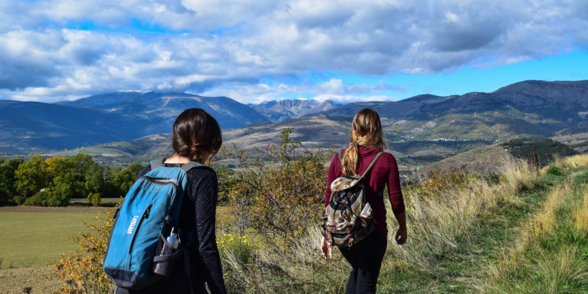 A picture of two women trekking and relishing the scenic views at the Prabalmachi.