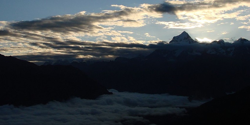 Morning panorama of Nanda Devi Peak, surrounded by misty valleys and illuminated by soft sunlight