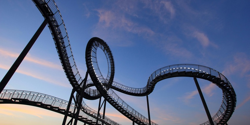 n image showing a thrilling rollercoaster ride at an amusement park with bright tracks.