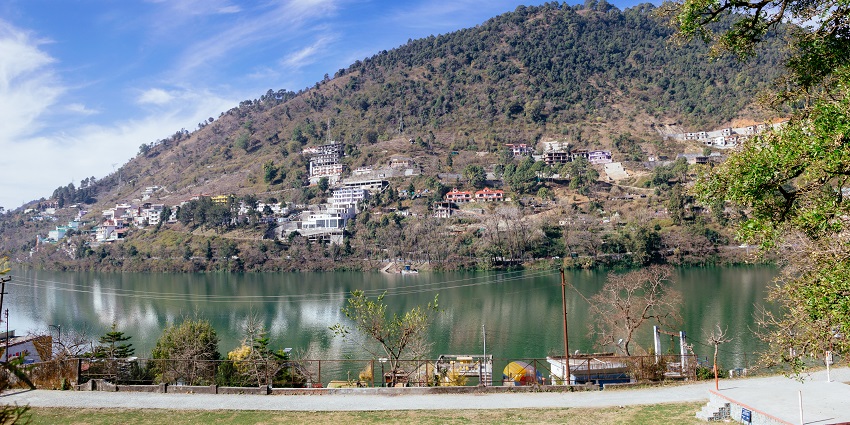Image of a scenic hill view across Bhimtal Lake, framed by tranquil waters and greenery.