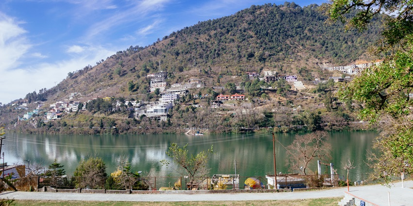 A picture of the scenic hills behind Bhimtal Lake offering views of the blue waters