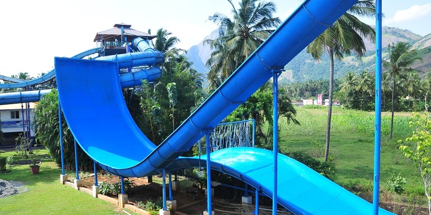 The main waterfall of the Black Thunder Water Theme Park with crowds of people.