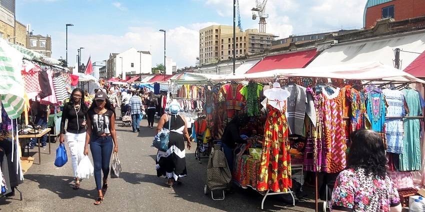 Busy street lined with shops and eateries for shopping.