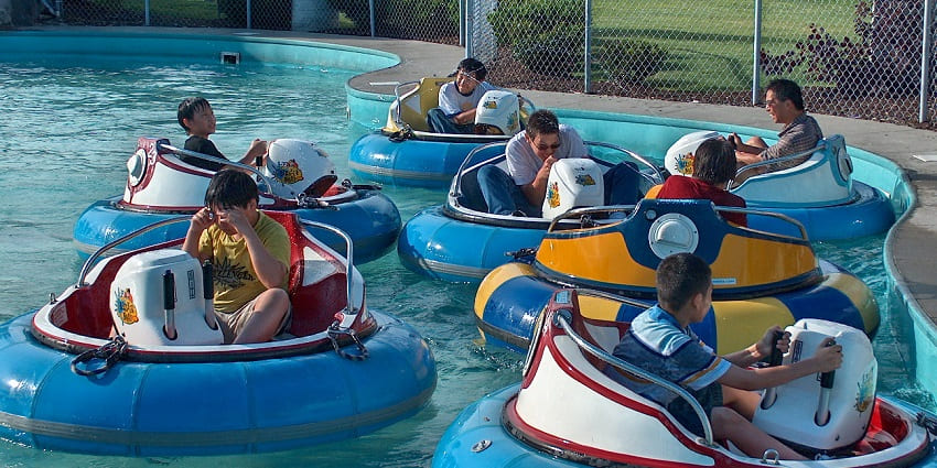 Image of tourists sitting in bumper boats and experiencing the thrill of the ride