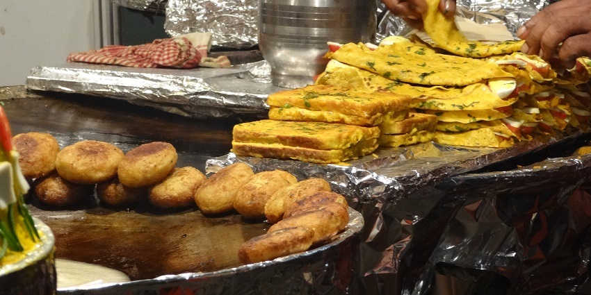 People enjoying spring rolls in the Chanda food, which is one of the best street items to eat.