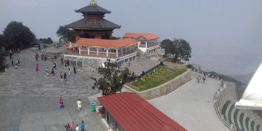 Chandragiri Hills with lush green slopes, cloudy sky, and scenic mountain landscape in view.