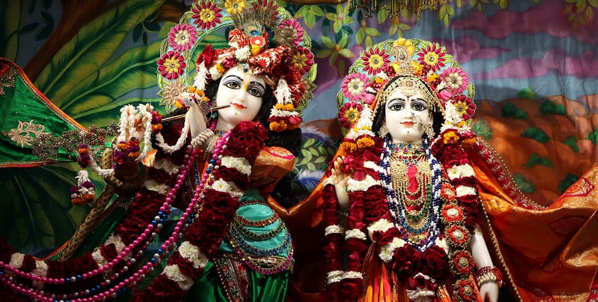 Image of idol Lord Krishna and Radha - ornate temple with a tall tower and intricate details stands against a blue sky