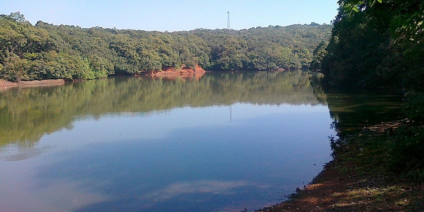 Charlotte Lake in Matheran surrounded by dense forest, reflecting sky hues near Pisharnath Mahadev Temple and Echo Point.