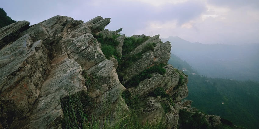 Chauli Ki Jali near Bhalu Gaad Waterfalls offers thrilling rock climbing opportunities