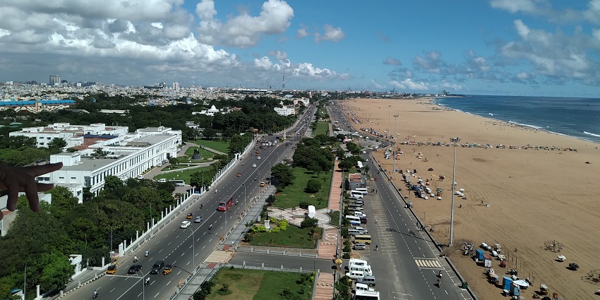 A bird's-eye view of Chennai city, showing buildings, roads, and greenery, a popular tourist place in Tamil Nadu.