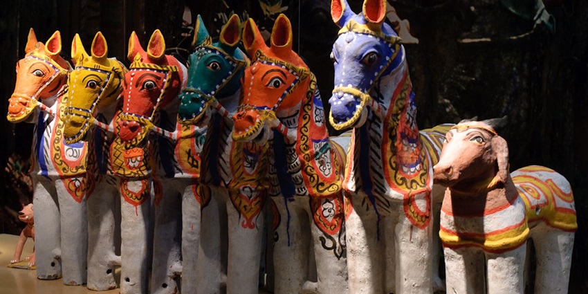 Mid-sized terracotta horses lined up together at an Ayyanar shrine as village guardians.