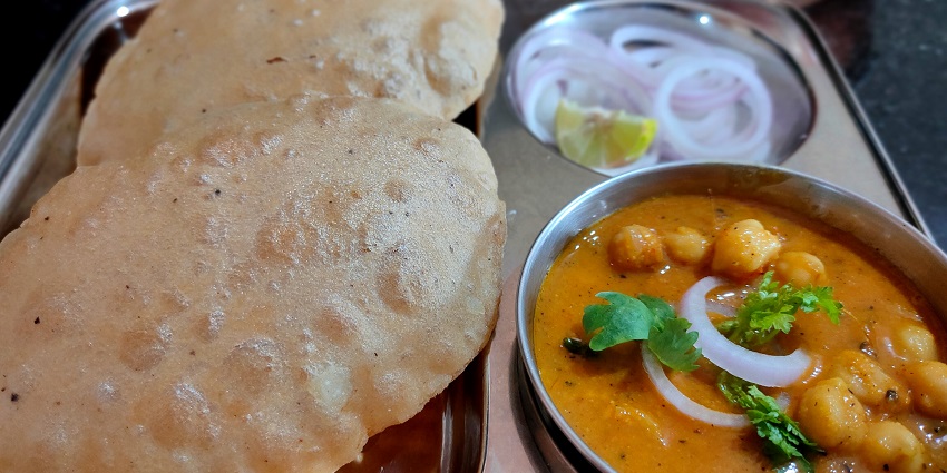 Spicy chickpeas paired with deep-fried bread, Poori. one of the best food in Dehradun