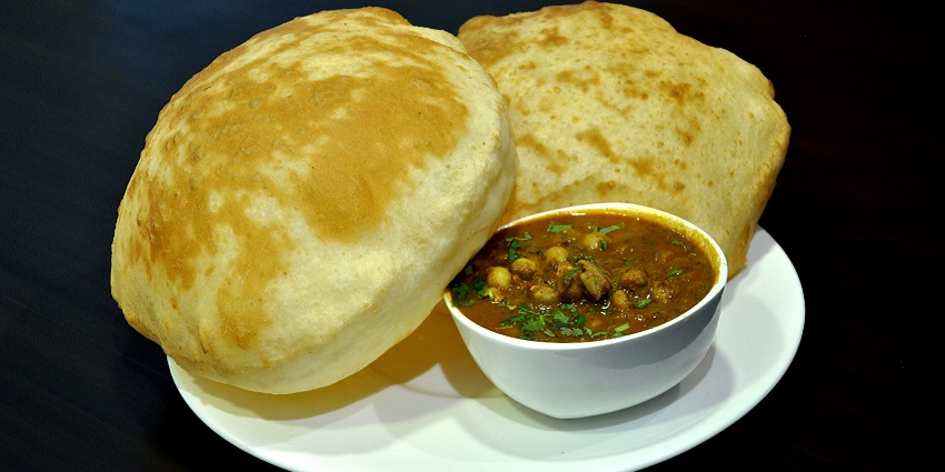 The famous food in Rishikesh is the spiced chickpeas served with fluffy deep-fried bread, bhature.