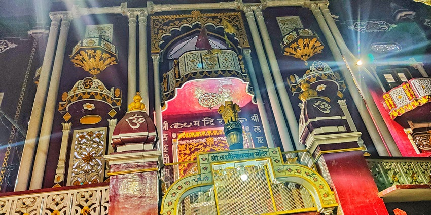A frontal view of a temple in Bareilly, decorated with multiple lights during night time