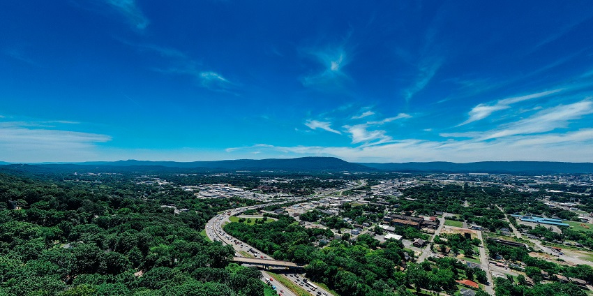 A picture of the City Forest in Ghaziabad and the highway, along with mountains.