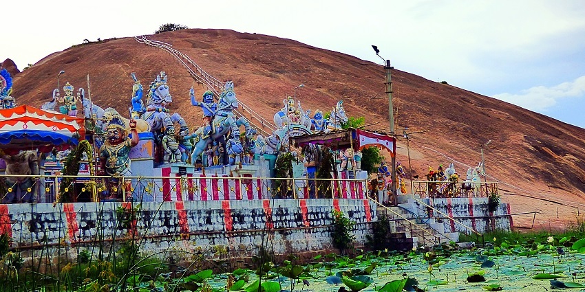 The Samanar Hills showcasing rugged terrain and lush greenery, with ancient rock-cut sculptures.