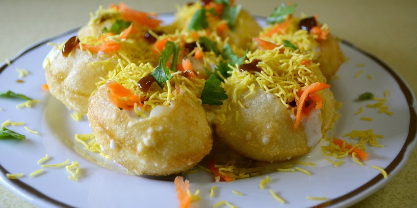Crunchy puris filled with yogurt, chutneys, and savory toppings.