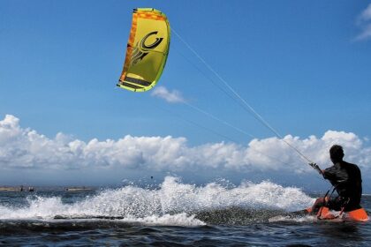 A vibrant view of Dandi Beach Water Sports, Gujarat, with jet skis on the shore.