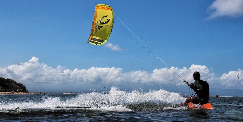 A vibrant view of Dandi Beach Water Sports, Gujarat, with jet skis on the shore.