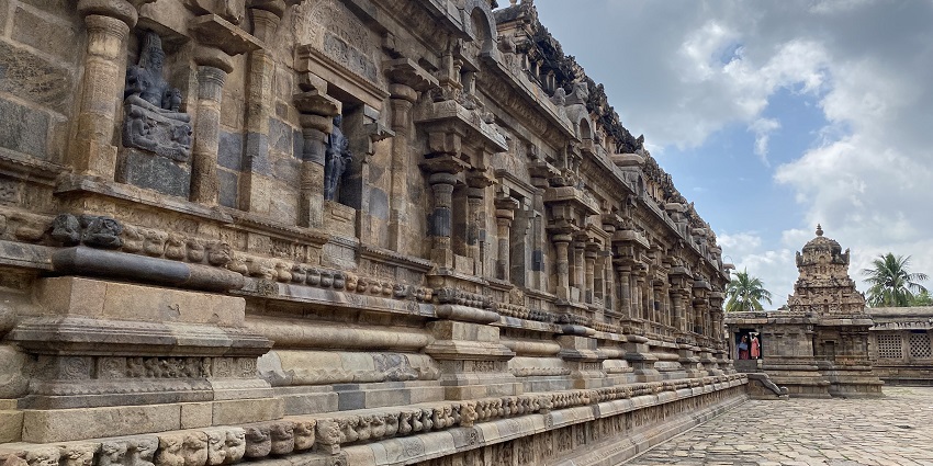 Dharasuram Airavatesvara Temple with intricate stone carvings and a temple complex.