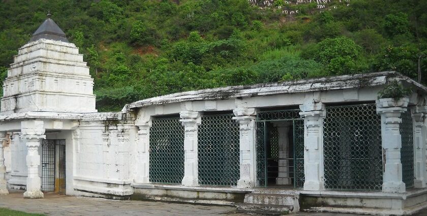 Dharmalingeswara Temple with white traditional architecture and surrounding greenery.