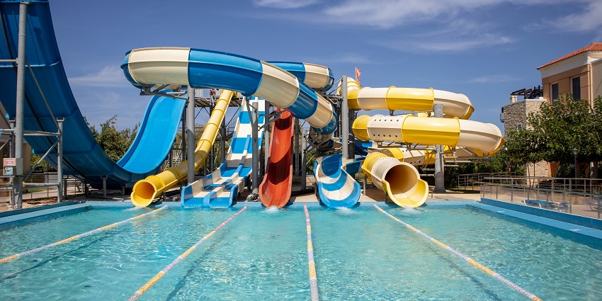 An image showing colourful slides at a waterpark, ready for exciting rides and splashes