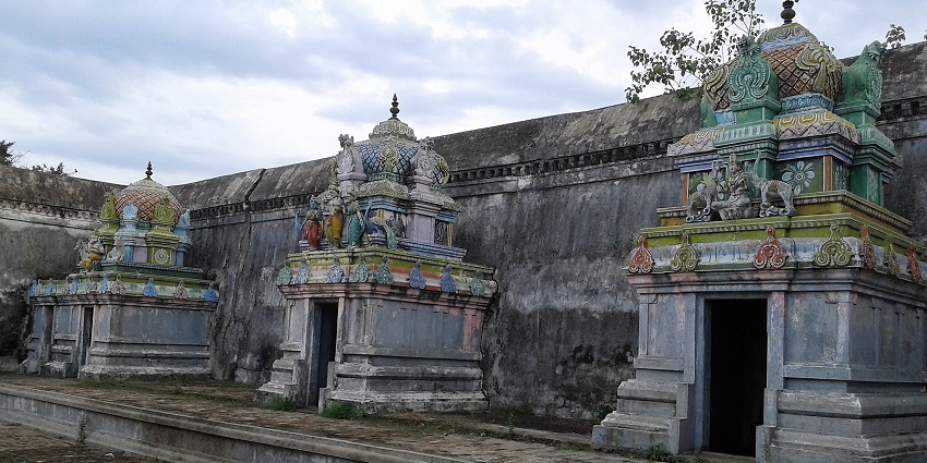 Architecture of Karkadeswarar Temple with intricate stone carvings and detailed sculptures.