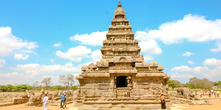 Lord Vishnu in Vamana avatar stands tall with raised leg inside ornate sanctum, situated near Periyandavar temple.