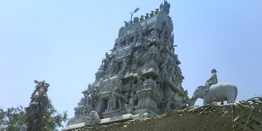 Eachanari Vinayagar Temple with detailed stone carvings and white marble statues.