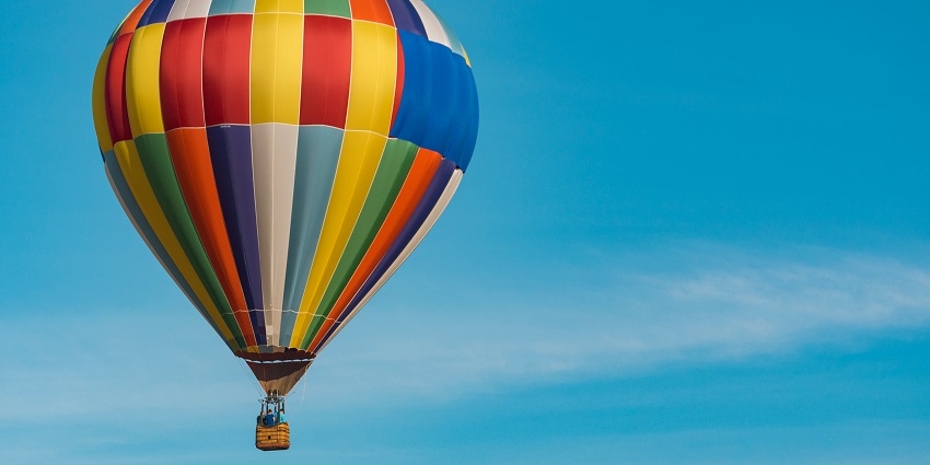 A glimpse of a colourful hot air balloon rising high up in the air in Uttarakhand.