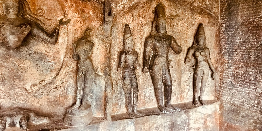8th-century cave temple with intricate architectural carvings and detailed sculptures.