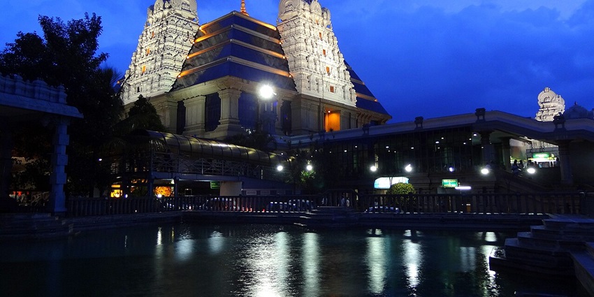 A view of the ISKCON temple featuring intricate architectural details and colourful domes.