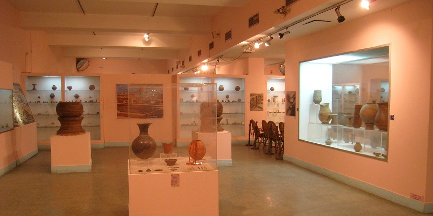 An interior image of the Taj Museum in Agra with numerous aged copper, and brass pottery tools.