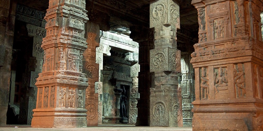 Intricate stone carvings and designed columns inside the halls of Airavatesvara Temple