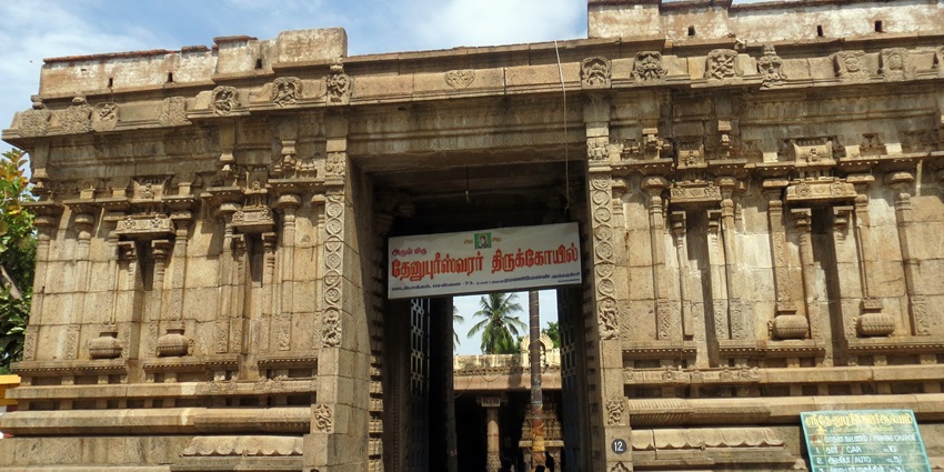 Dhenupureeswarar Temple's detailed architecture with ornate carvings and an entrance.