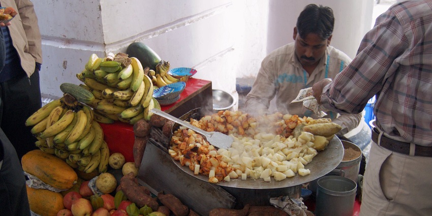 Mixed fruit salad tossed with spices for flavour being served by a street vendor.