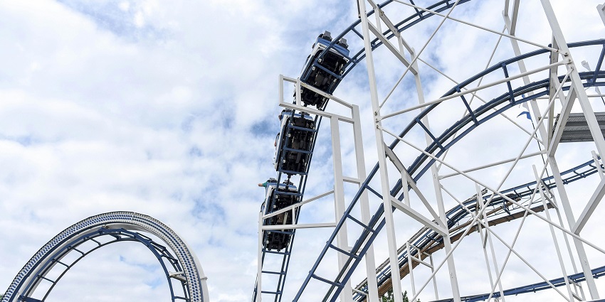 An image of a white roller coaster twisting - one of the amusement park in Tamil Nadu.