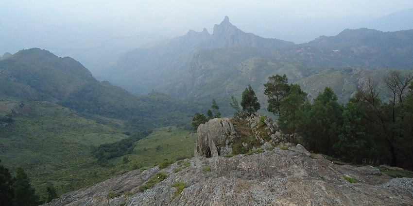 An aerial view of a mesmerising landscape with lush greenery and misty air
