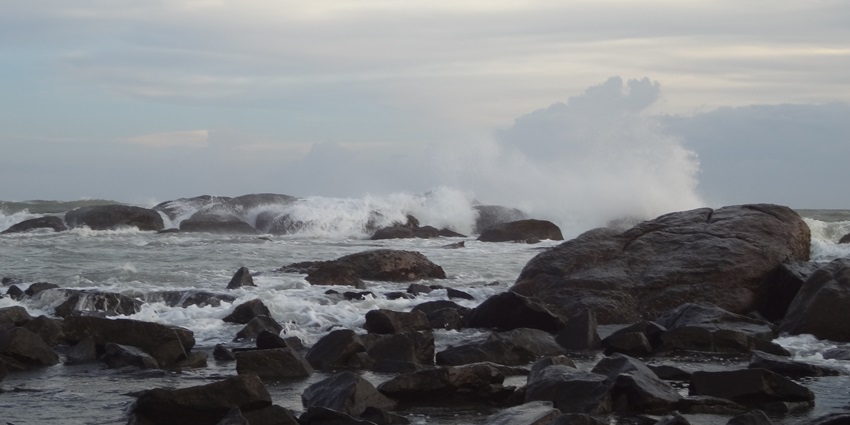 A scenic coastal view with a river meeting the sea, a tourist attraction near Jaigad Fort.