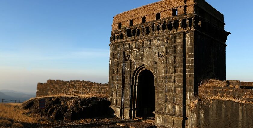 A panoramic view of a Ghangad fort, with the clear blue sky in the backdrop