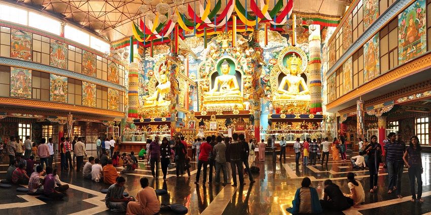 Places to visit in Kushalnagar feature a majestic Tibetan monastery with stunning golden statues and architecture.