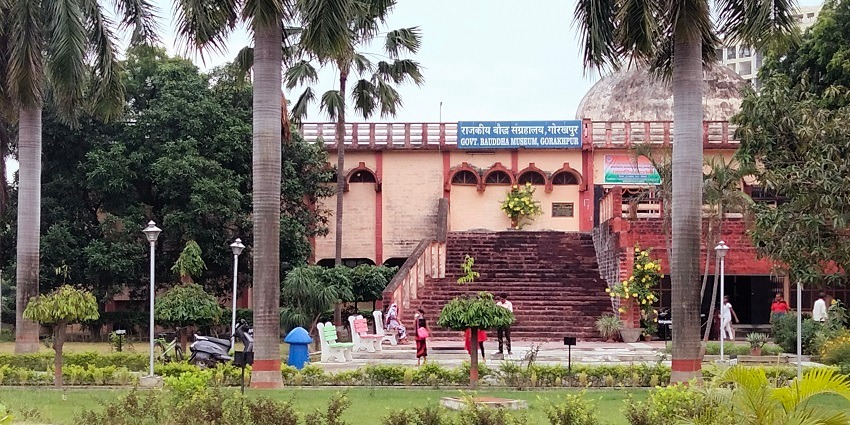 A museum with a tall arched entrance, large windows, and detailed stone architecture.