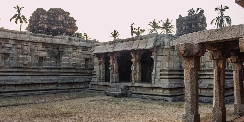 A scenic picture of Goswami Tulsidas temple with a courtyard and carved pillars.