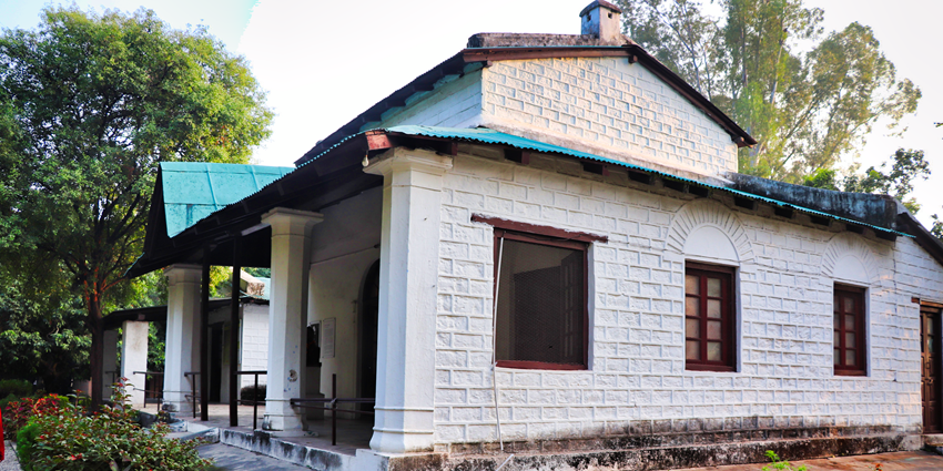 Corbett House at Kaladhungi surrounded by trees and historic colonial architecture.